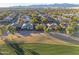 Aerial view of property with golf course, mountain views and houses at 3755 N 161St Ave, Goodyear, AZ 85395