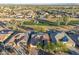 Aerial view of single-story house with solar panels and golf course views at 3755 N 161St Ave, Goodyear, AZ 85395