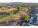 Aerial view showcasing a house near a golf course and mountain views at 3755 N 161St Ave, Goodyear, AZ 85395