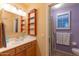 Bright bathroom with double sinks, built-in shelves and shower at 3755 N 161St Ave, Goodyear, AZ 85395