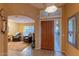 Bright and airy entryway with wood door and view of living room at 3755 N 161St Ave, Goodyear, AZ 85395