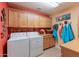 Laundry room with washer, dryer, and ample cabinets at 3755 N 161St Ave, Goodyear, AZ 85395