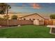 Neatly landscaped backyard with storage shed and wooden gate at 3829 E Sawtooth Dr, Chandler, AZ 85249