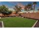 Landscaped backyard with lush lawn and privacy wall at 3829 E Sawtooth Dr, Chandler, AZ 85249