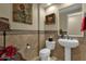 Elegant powder room with pedestal sink and tile accents at 3829 E Sawtooth Dr, Chandler, AZ 85249