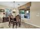 Charming dining area with window views and custom light fixture at 3829 E Sawtooth Dr, Chandler, AZ 85249