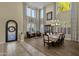 Formal dining room with hardwood floors, chandelier, and large windows at 3829 E Sawtooth Dr, Chandler, AZ 85249