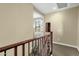 Upstairs hallway with wood railing and access to bedrooms at 3829 E Sawtooth Dr, Chandler, AZ 85249