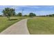 Paved walkway winds through a grassy park with trees and playground at 3829 E Sawtooth Dr, Chandler, AZ 85249