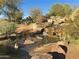 Serene desert landscape with a tranquil waterfall and pond at 3829 E Sawtooth Dr, Chandler, AZ 85249