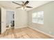 Bedroom with wood-look floors, ceiling fan and access to bathroom at 4033 N 14Th Pl, Phoenix, AZ 85014