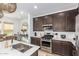 Modern kitchen with dark cabinets, quartz countertops, and stainless steel appliances at 4077 S Sabrina Dr # 24, Chandler, AZ 85248