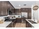 Modern kitchen with dark cabinets, quartz countertops, and stainless steel appliances at 4077 S Sabrina Dr # 24, Chandler, AZ 85248