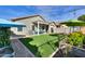 Artificial turf backyard with a pergola and colorful umbrellas at 4129 E Cathy Dr, Gilbert, AZ 85296