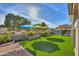 Expansive backyard with multiple umbrellas and artificial turf at 4129 E Cathy Dr, Gilbert, AZ 85296