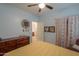 Light blue bedroom with yellow bedding, ceiling fan, and adjacent bathroom at 4129 E Cathy Dr, Gilbert, AZ 85296