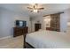 Primary bedroom with king bed, dresser, and barn door to bath at 4129 E Cathy Dr, Gilbert, AZ 85296