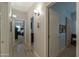 Bright hallway with wood-look tile floors and access to bedrooms at 4129 E Cathy Dr, Gilbert, AZ 85296