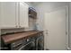 Well-appointed laundry room with LG washer and dryer, and wood countertop at 4129 E Cathy Dr, Gilbert, AZ 85296