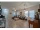 Open living area with L-shaped sofa, wood flooring, and large windows at 4129 E Cathy Dr, Gilbert, AZ 85296