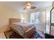 Bright bedroom with wood bed frame and ceiling fan at 4200 N Miller Rd # 121, Scottsdale, AZ 85251