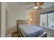 Cozy bedroom with wood platform bed and ceiling fan at 4200 N Miller Rd # 121, Scottsdale, AZ 85251