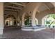 Elegant building entrance with arched entryway, fountain, and brick pavers at 4200 N Miller Rd # 121, Scottsdale, AZ 85251