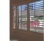 Window with white plantation shutters and a view of trees at 4200 N Miller Rd # 121, Scottsdale, AZ 85251