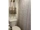 Clean bathroom with toilet and striped shower curtain at 4444 E Paradise Village N Pkwy # 107, Phoenix, AZ 85032