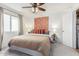 Comfortable bedroom with a large bed and wall art at 4444 E Paradise Village N Pkwy # 107, Phoenix, AZ 85032