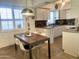 Bright kitchen with white cabinets, wood table, and modern pendant lighting at 4444 E Paradise Village N Pkwy # 107, Phoenix, AZ 85032