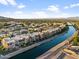 Aerial view of community by a canal with mountain views at 4803 N Woodmere Fairway -- # 2002, Scottsdale, AZ 85251