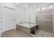 Bathroom with a soaking tub, glass shower, and modern fixtures at 4803 N Woodmere Fairway -- # 2002, Scottsdale, AZ 85251