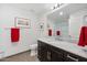 Modern bathroom with dark vanity, marble countertop, and shower at 4803 N Woodmere Fairway -- # 2002, Scottsdale, AZ 85251