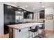 Modern kitchen with dark cabinetry, granite countertops, and stainless steel appliances at 4803 N Woodmere Fairway -- # 2002, Scottsdale, AZ 85251