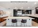 Modern kitchen with dark cabinetry, granite countertops, and stainless steel appliances at 4803 N Woodmere Fairway -- # 2002, Scottsdale, AZ 85251