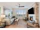 Relaxing living room with fireplace, hardwood floors, and large windows at 4803 N Woodmere Fairway -- # 2002, Scottsdale, AZ 85251