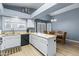 Kitchen with island, white cabinets, and black appliances at 510 E Desert Hills Estate Dr, Phoenix, AZ 85086