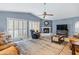 Living room with fireplace, leather furniture, and large windows at 510 E Desert Hills Estate Dr, Phoenix, AZ 85086