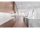 Modern kitchen with marble countertops and wood cabinets at 5740 E Moura Dr, Cave Creek, AZ 85331