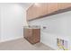 Laundry room with wooden cabinets and countertop at 5740 E Moura Dr, Cave Creek, AZ 85331