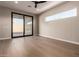 Bedroom with hardwood floors, sliding door to patio and window at 5748 E Moura Dr, Cave Creek, AZ 85331