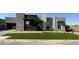 Stunning modern home boasts stylish architecture, desert landscaping, and lush artificial turf at 5748 E Moura Dr, Cave Creek, AZ 85331