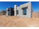 Side view of a sleek, modern home with neutral colors at 5748 E Moura Dr, Cave Creek, AZ 85331