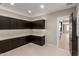 Laundry room with herringbone tile floor and access to kitchen at 5748 E Moura Dr, Cave Creek, AZ 85331