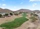 Aerial view of a golf course community with mountain views at 6210 W Foothill Dr, Glendale, AZ 85310