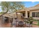 Outdoor kitchen, fire pit, and seating area in a spacious backyard at 6210 W Foothill Dr, Glendale, AZ 85310