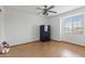 Simple bedroom with wood flooring and a large window at 6210 W Foothill Dr, Glendale, AZ 85310