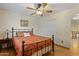 Bedroom with iron bed frame and ceiling fan at 6210 W Foothill Dr, Glendale, AZ 85310