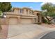 Tan two-story house with a three-car garage and landscaping at 6210 W Foothill Dr, Glendale, AZ 85310